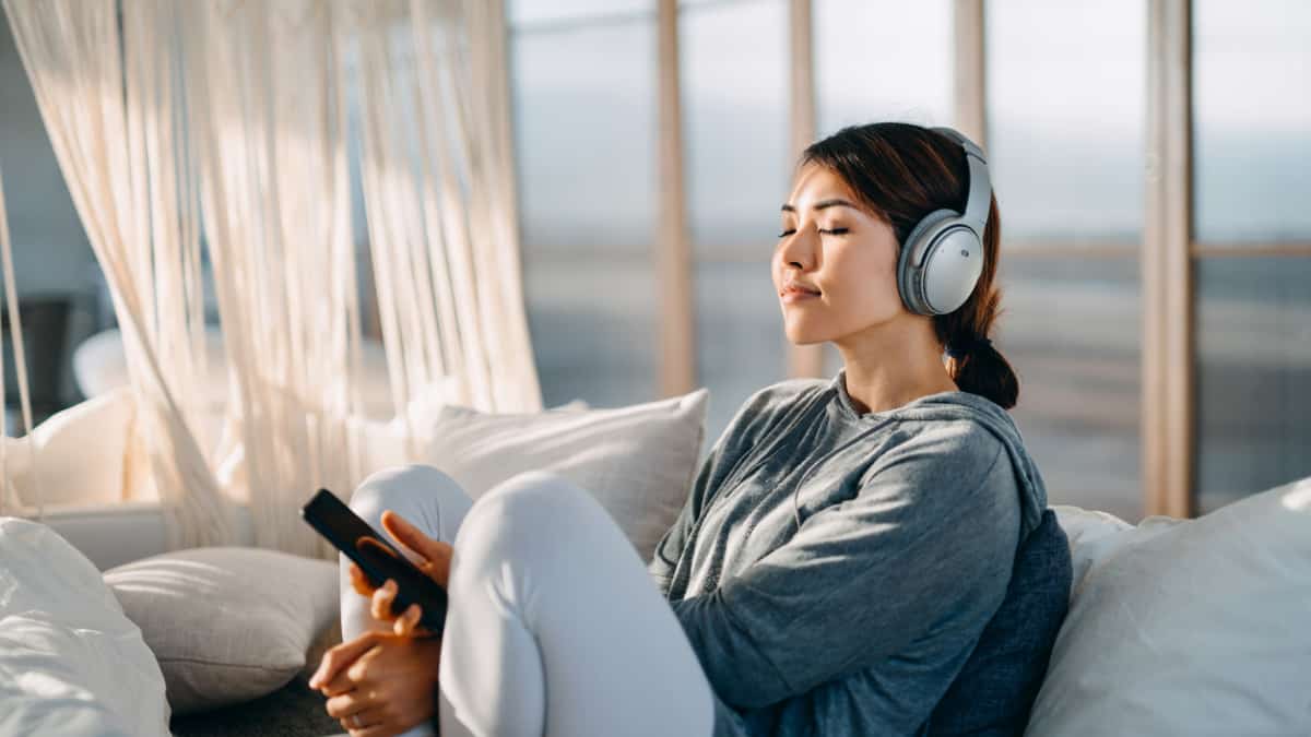woman dealing with burnout listening to music or podcast