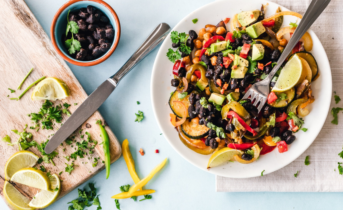 black beans with veggies and avocado on a counter